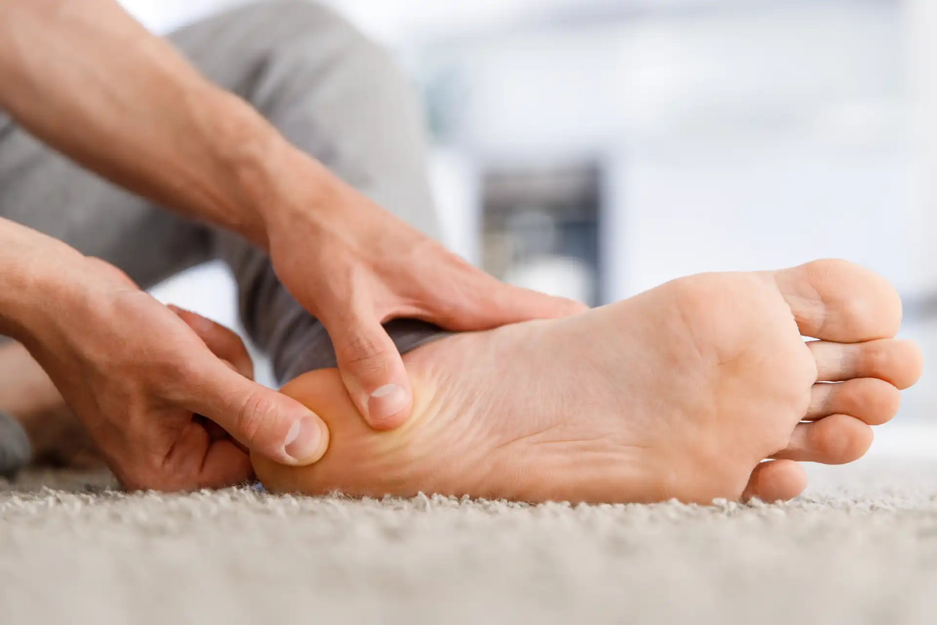 plantar fasciitis concept image person massaging foot